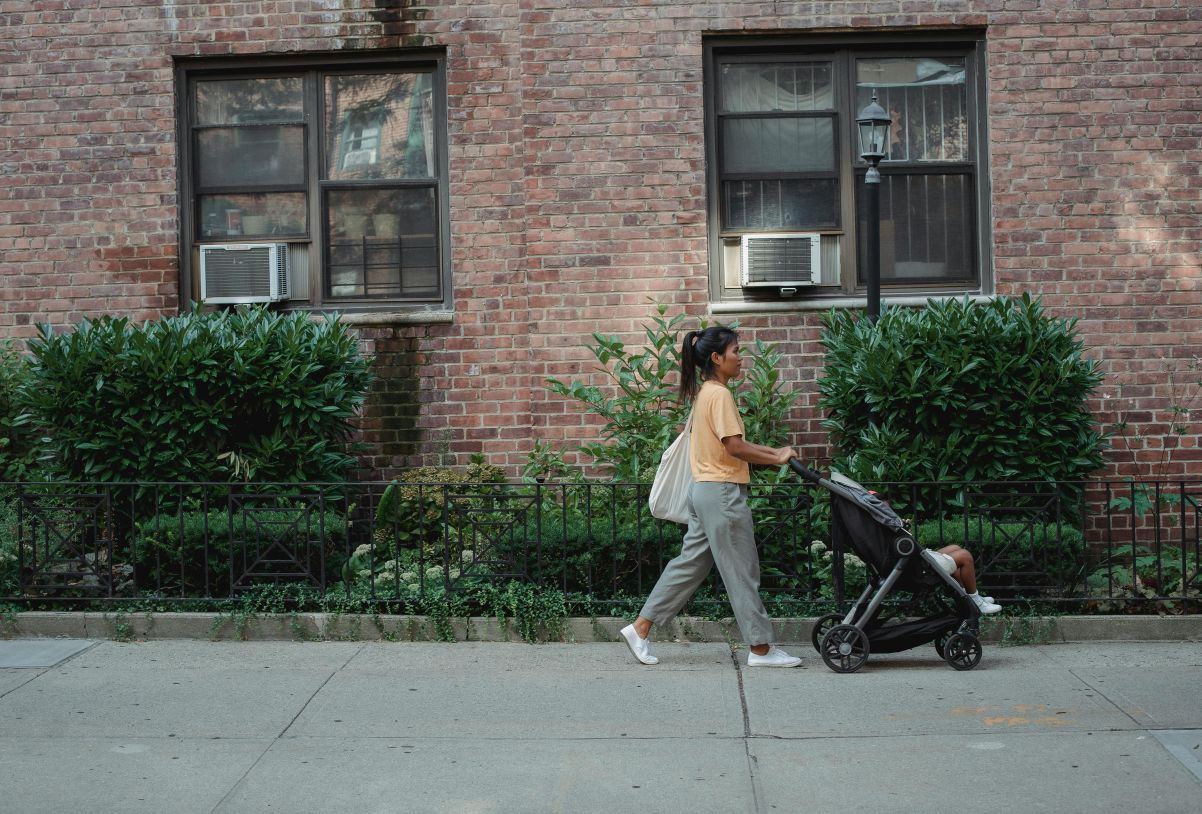 Woman with pushchair on street